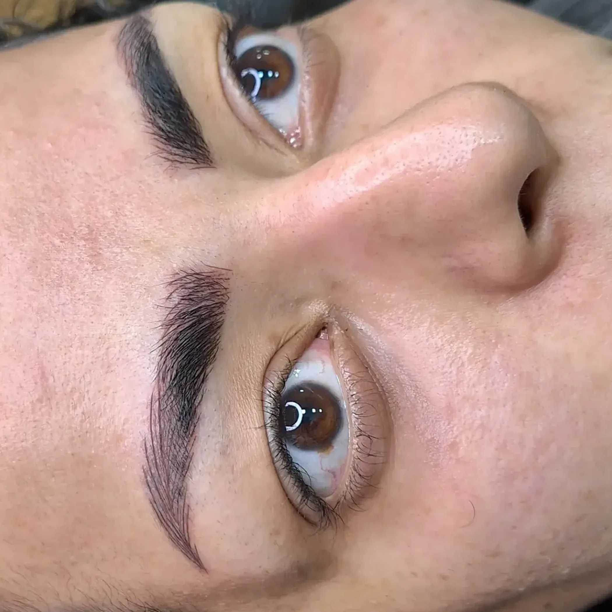 close-up of eyebrow microblading procedure