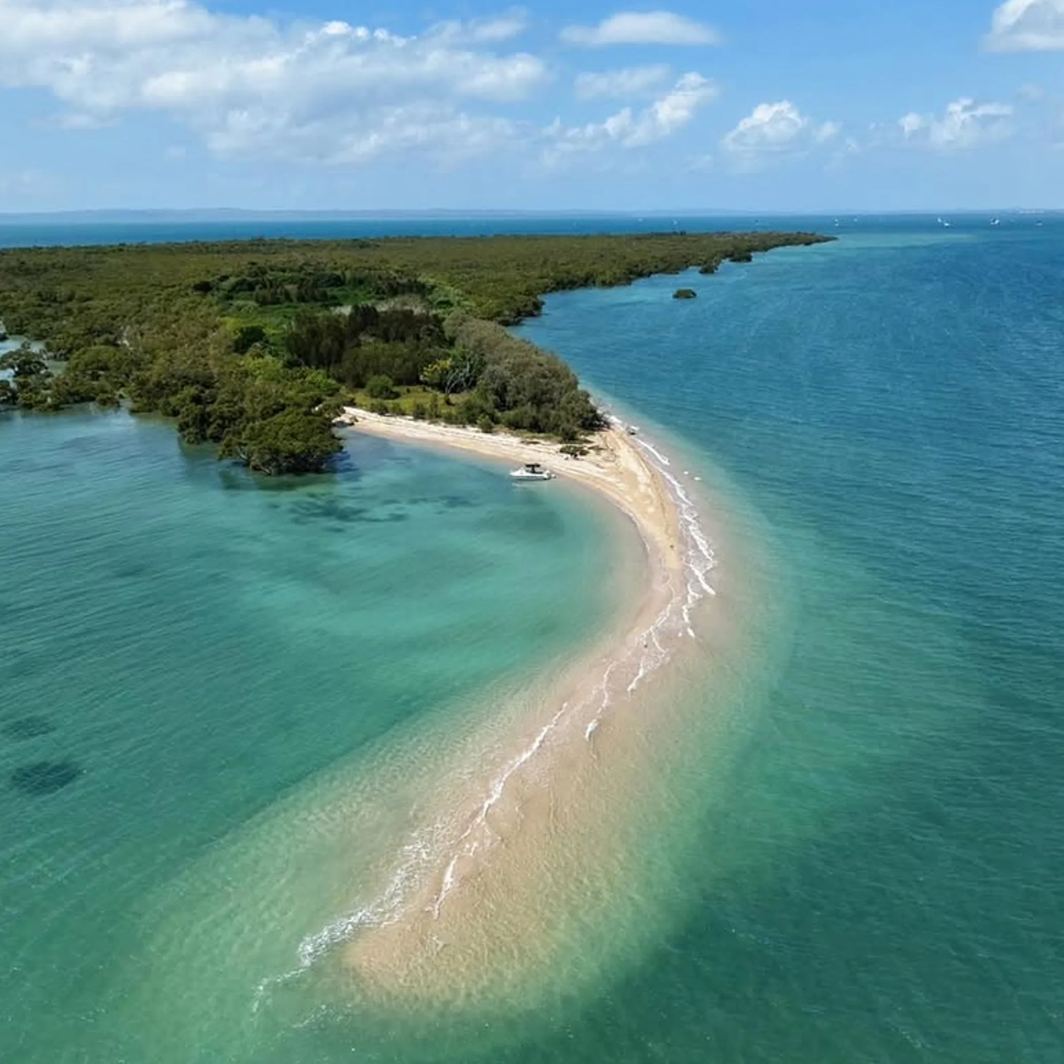 island beach with shallow waters and boat access