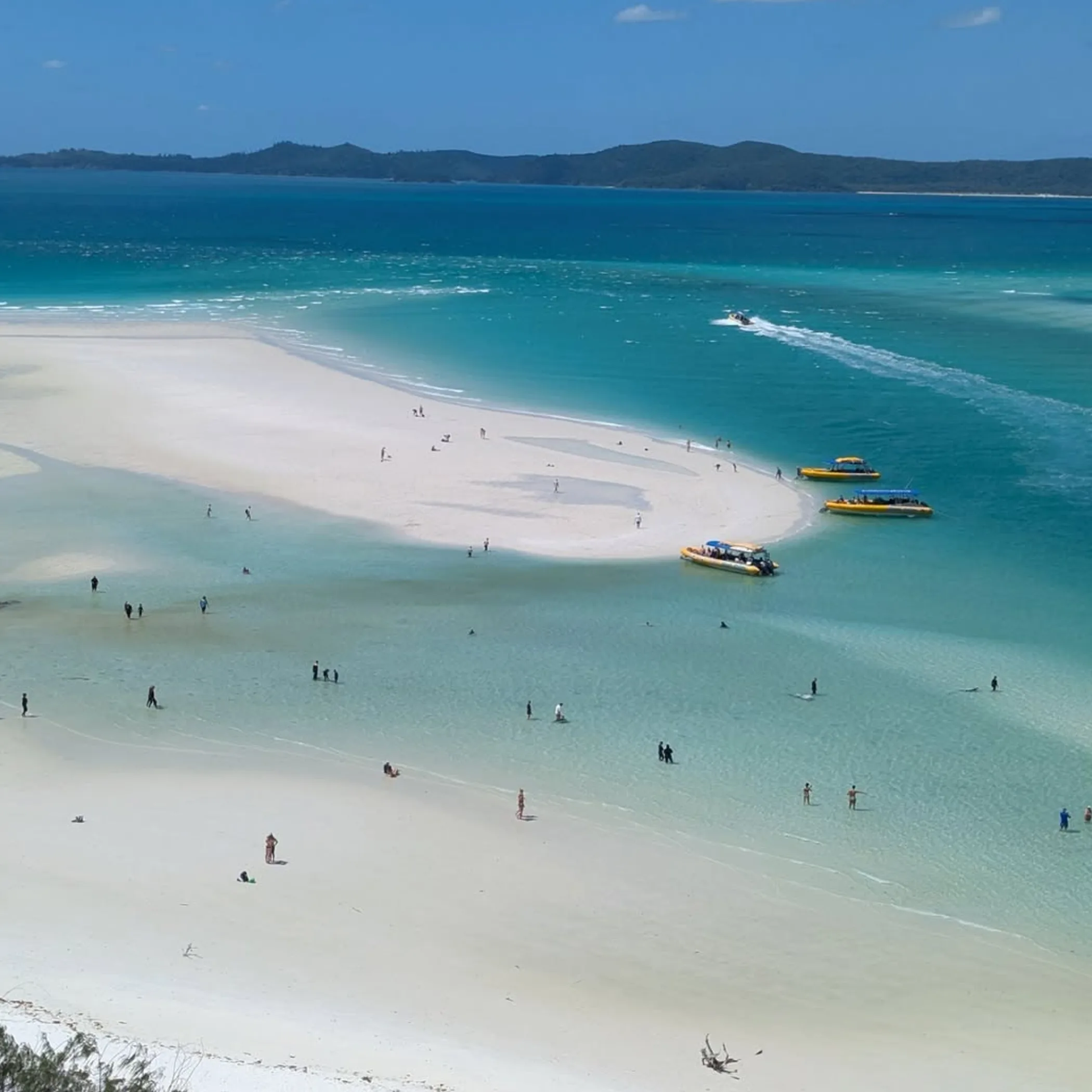 island beach with transfer boats